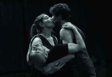 Photo du spectacle Les Mains chaudes avec une photo de trois personnes en noir et blanc deux s'embrassent en soutenant le troisième qui part la tête en arrière